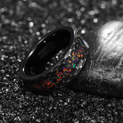 Black ring with multicolored interior on a textured surface