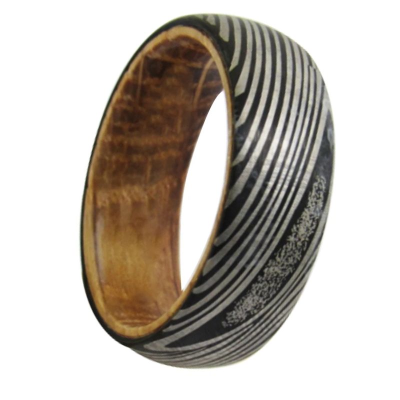 Ring with wooden and patterned metal band